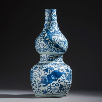 A Chinese blue and white 'Animals and Peony Scrolls' double-gourd vase, Wanli