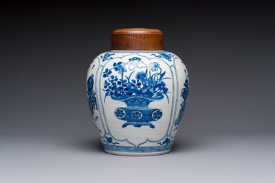 A Chinese blue and white 'Antiquities and Flower Baskets' vase with a wooden cover, Kangxi