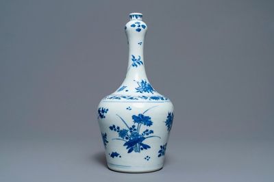 A Chinese blue and white bottle vase with floral design, Transitional period