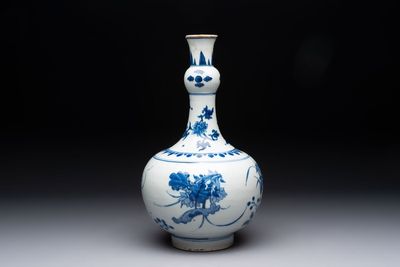 A Chinese blue and white bottle vase with floral design, Transitional period