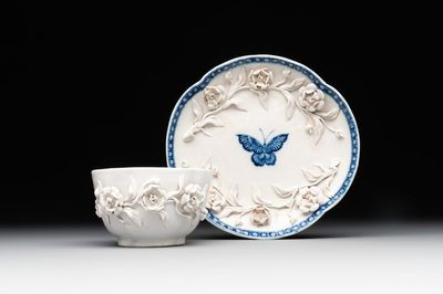 A Chinese blue and white 'butterfly' cup and saucer with applied floral design, Qianlong