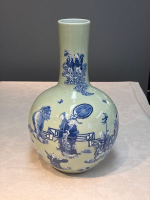 A Chinese blue and white celadon-ground 'Sanxing' bottle vase with relief design, 19th C. — photo 1