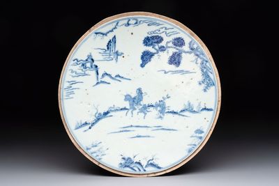 A Chinese blue and white circular plaque with two figures in a landscape, 19/20th C.