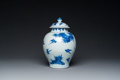 A Chinese blue and white covered vase with birds among blossoming branches, Transitional period