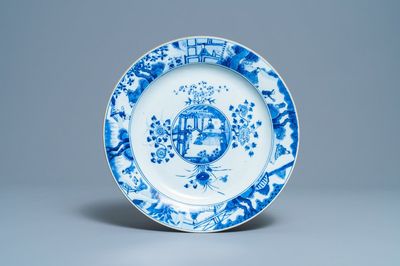 A Chinese blue and white dish with raised central medallion, Kangxi
