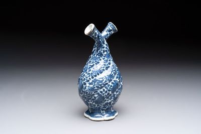 A Chinese blue and white double-spouted swirling-lobed cruet, Kangxi