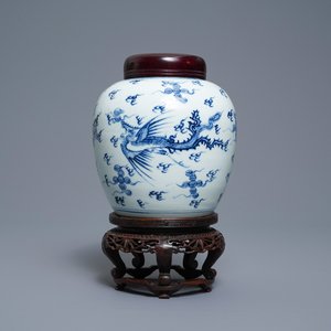 A Chinese blue and white 'dragon and phoenix' jar with wooden cover and stand, Kangxi — photo 1