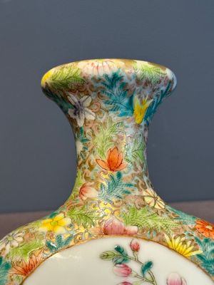 A Chinese blue and white 'dragon' vase, a famille rose 'millefleurs' vase and a teapot, Qianlong mark, 19/20th C. — photo 22