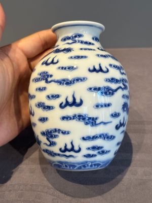 A Chinese blue and white 'dragon' vase, a famille rose 'millefleurs' vase and a teapot, Qianlong mark, 19/20th C. — photo 4