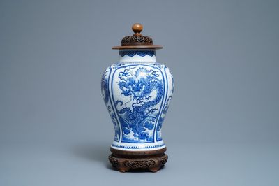 A Chinese blue and white 'dragon' vase with wooden cover and stand, Kangxi