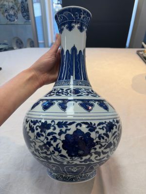 A Chinese blue and white 'flower scroll' bottle vase, Xuantong mark, 20th C. — photo 1