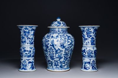 A Chinese blue and white garniture of three vases with floral and landscape design, Kangxi