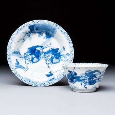 A Chinese blue and white 'Hunting Scene' tea bowl and saucer, jade mark, Kangxi