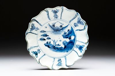 A Chinese blue and white ko-sometsuke flower-shaped tripod 'landscape' plate for the Japanese market, late Ming
