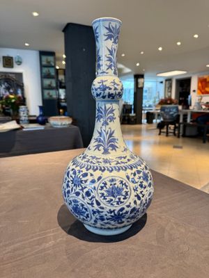 A Chinese blue and white 'lotus scroll' bottle vase, Transitional period — photo 1