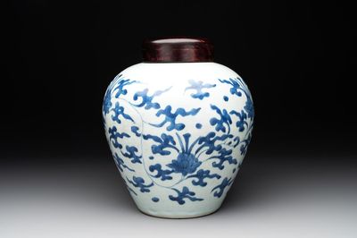 A Chinese blue and white 'lotus scroll' vase with wooden cover, Kangxi