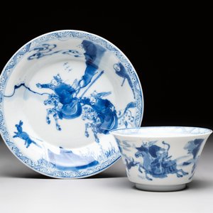 A Chinese blue and white 'Mongolian hunting' cup and saucer, jade mark, Kangxi — photo 1