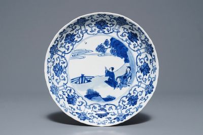 A Chinese blue and white moulded plate with figures in a landscape, Kangxi mark and of the period