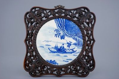 A Chinese blue and white plaque in sculpted frame, 19th C.