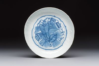 A Chinese blue and white plate with a relief-moulded rim, Wanli