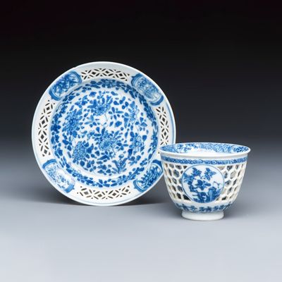 A Chinese blue and white reticulated 'Linglong' tea bowl and saucer, Kangxi