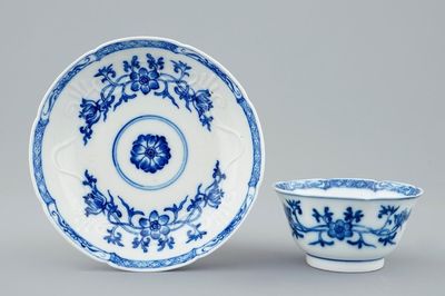 A Chinese blue and white soft paste moulded cup and saucer, Qianlong, 18th C.