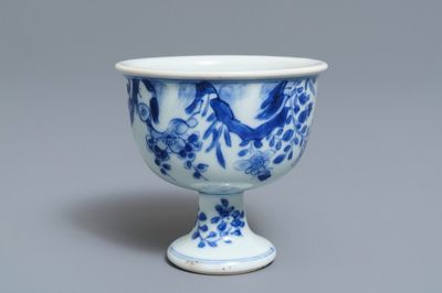 A Chinese blue and white stem cup with birds among blossoms, Transitional period