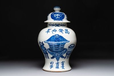 A Chinese blue and white vase and cover with calligraphy and antiquities, 19th C.