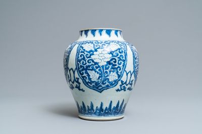A Chinese blue and white vase with floral panels, Kangxi