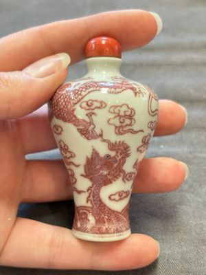 A Chinese blue, white and copper-red 'dragon' snuff bottle, 19th C. — photo 1