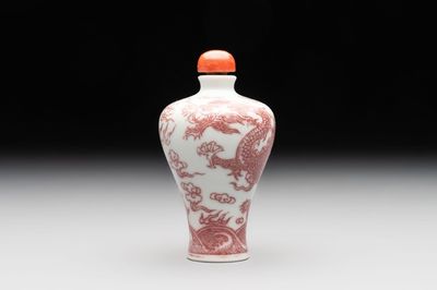 A Chinese blue, white and copper-red 'dragon' snuff bottle, 19th C.
