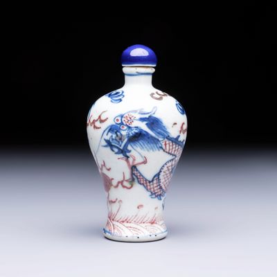 A Chinese blue, white and copper-red 'Dragon' snuff bottle, 19th C.