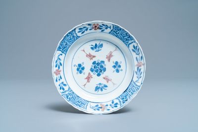 A Chinese blue, white and copper red 'fish' plate, Chenghua mark, Kangxi
