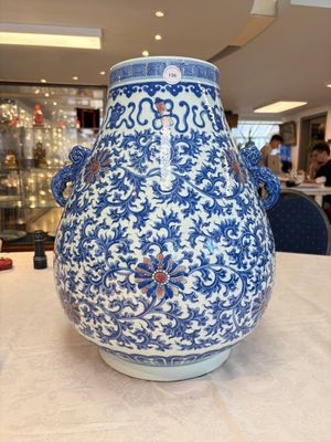A Chinese blue, white and copper-red 'hu' vase with lotus scrolls, Qianlong mark, 19th C. — photo 1