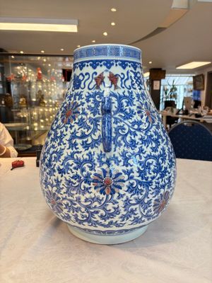 A Chinese blue, white and copper-red 'hu' vase with lotus scrolls, Qianlong mark, 19th C. — photo 2