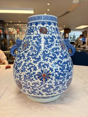 A Chinese blue, white and copper-red 'hu' vase with lotus scrolls, Qianlong mark, 19th C. — photo 3