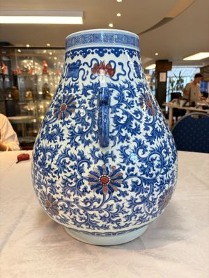 A Chinese blue, white and copper-red 'hu' vase with lotus scrolls, Qianlong mark, 19th C. — photo 4