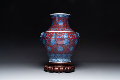 A Chinese blue, white and iron-red 'bajixiang' 'hu' vase on wooden stand, Qianlong mark, 19th C.