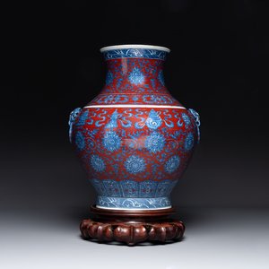 A Chinese blue, white and iron-red 'bajixiang' 'hu' vase on wooden stand, Qianlong mark, 19th C. — photo 1