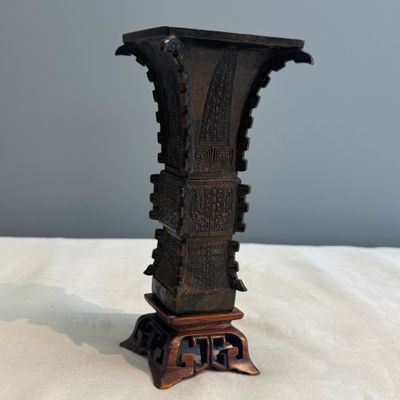 A Chinese bronze archaistic fang zun on a later wooden stand — photo 1