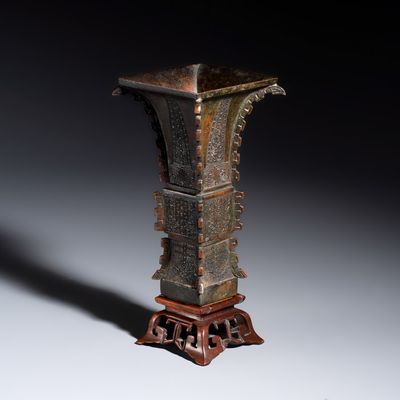 A Chinese bronze archaistic fang zun on a later wooden stand, Ming