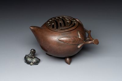 A Chinese bronze camel-form paperweight and a peach-shaped covered censer, 19th C.