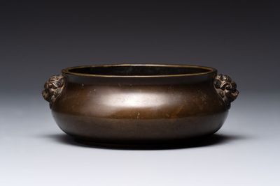 A Chinese bronze censer with lion-form handles, 大明宣德五年監造工部官監吳邦佐造 mark, 18th C.