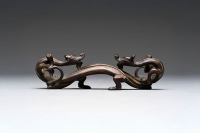A Chinese bronze 'dragon' brush rest, Song/Yuan