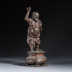 A Chinese bronze figure of a foreigner standing on a pedestal — photo 1