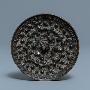 A Chinese bronze mirror with relief design, Tang — photo 1