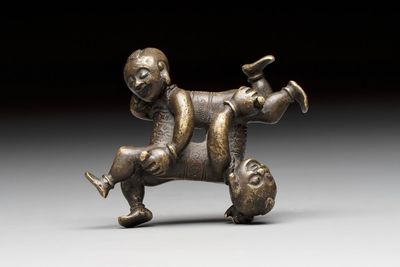 A Chinese bronze scroll weight in shape of two boys, Qing