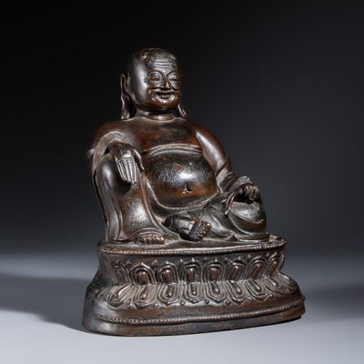 A Chinese bronze seated Budai on a lotus throne, Ming