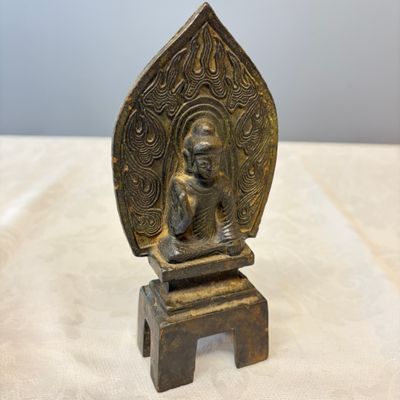 A Chinese bronze seated Buddha with a flaming halo — photo 1