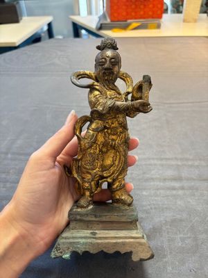 A Chinese bronze Taoist figure and a gilt-lacquered guardian, Ming — photo 1